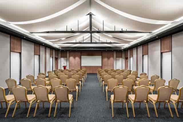 Modern conference room with architectural ceiling for corporate presentations and seminars.