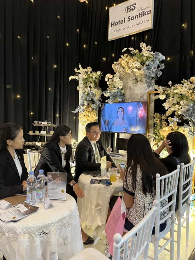 Hotel Santika ballroom wedding consultation with floral decor and event planning services.