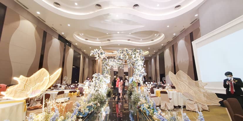 Luxury ballroom wedding venue with floral arch and runway at Hotel Santika Premiere Hayam Wuruk.