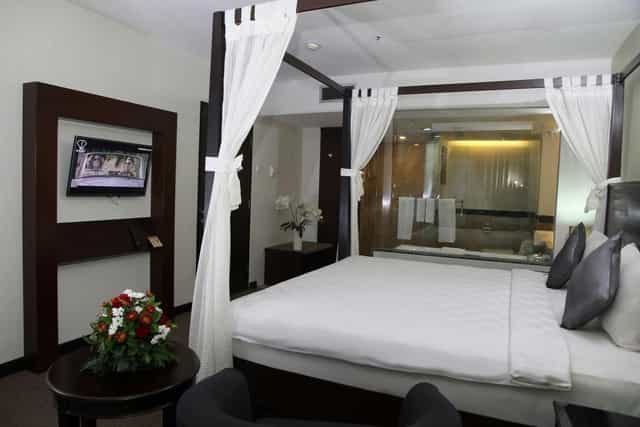 Luxury hotel suite with four-poster bed for VIP event accommodation and incentive travel.