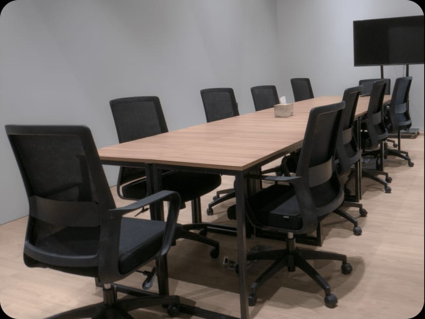Functional Mantra Space boardroom with wood table for corporate meetings and team huddles.