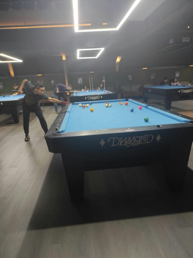 Team building breakout session at Mantra Space featuring professional office billiards tables.