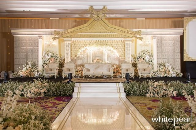 Grand Ballroom wedding stage with floral decor at JS Luwansa Hotel Jakarta, luxury event venue.