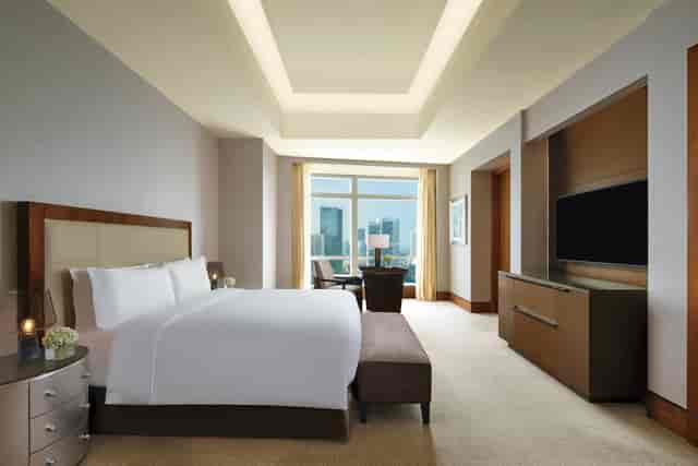 Luxury Ritz-Carlton Jakarta suite with floor-to-ceiling windows for VIP executive lodging.