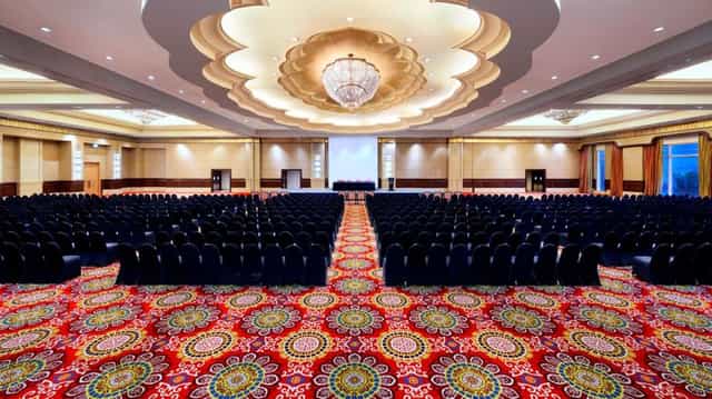 Ritz-Carlton Jakarta ballroom theater setup with architectural ceiling for large conferences.