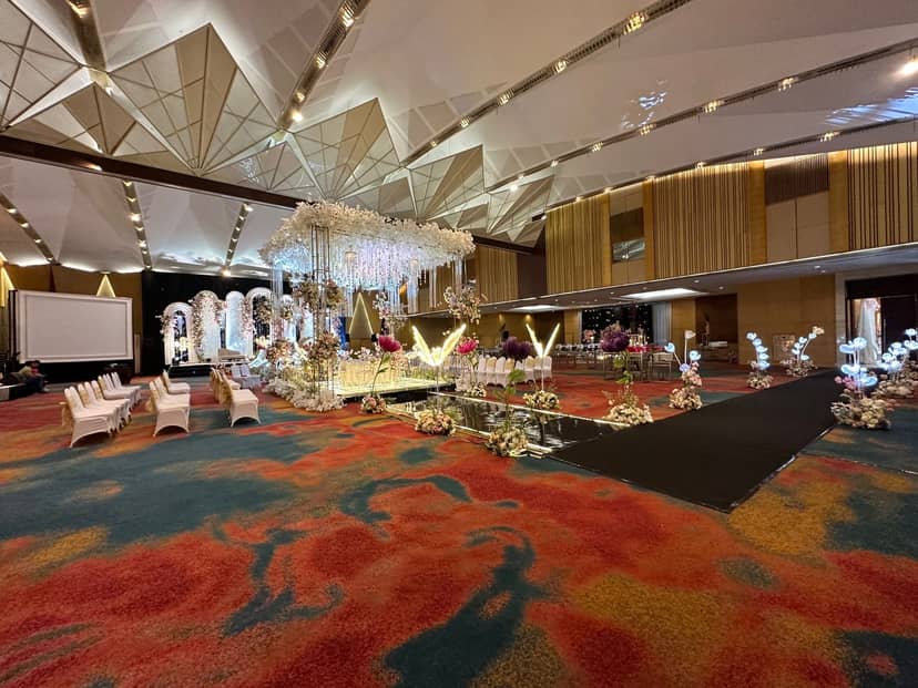 Luxury ballroom with floral aisle at Hotel Ciputra Jakarta for elegant weddings and gala events.