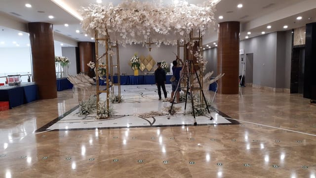 HK Tower wedding ballroom setup with custom floral canopy for luxury event ceremony.