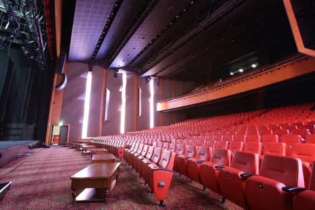 MNC Land theater with tiered seating and stage lighting for awards gala or hybrid events.