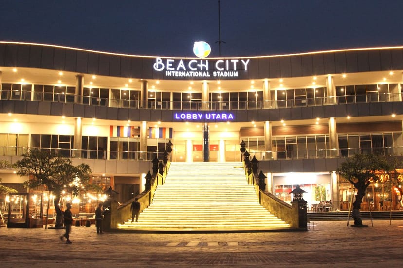 Illuminated grand staircase at Sunset Beach, Beach City Stadium for red-carpet event registration.