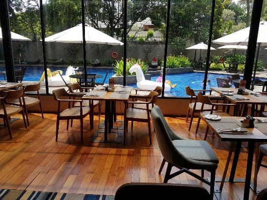 Swiss-Café Restaurant pool view dining space for corporate networking and team-building events.