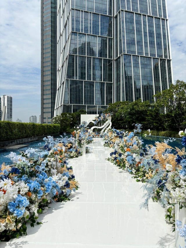 Luxury outdoor wedding and corporate event venue, Alila SCBD Jakarta with floral aisle.