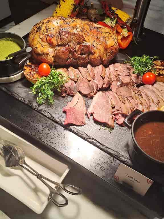 High-end buffet catering with rustic slate staging for luxury corporate events.