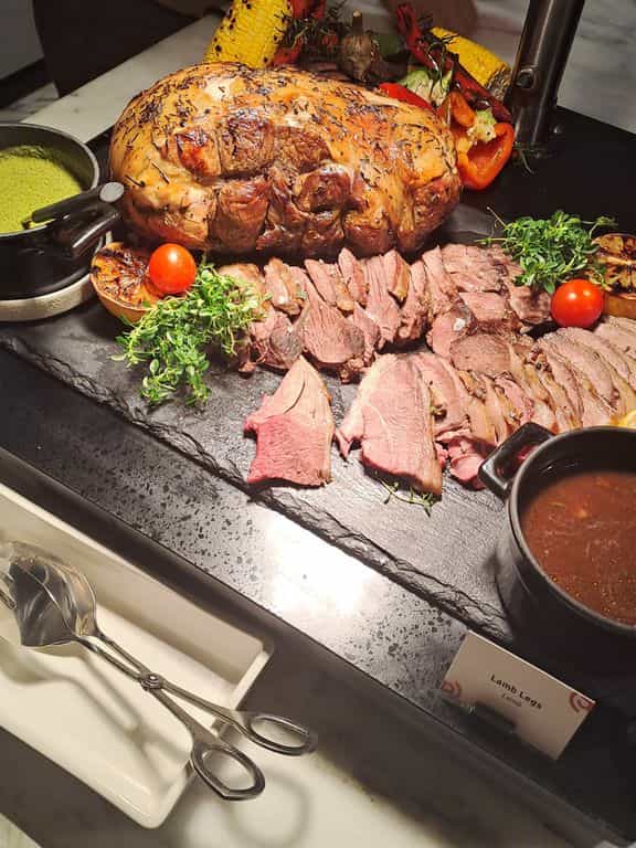 High-end buffet catering with rustic slate staging for luxury corporate events.