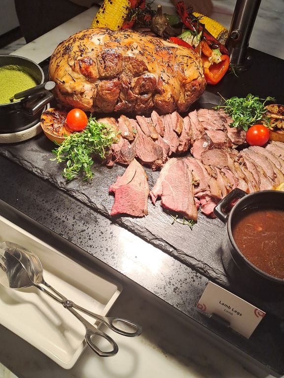 High-end buffet catering with rustic slate staging for luxury corporate events.