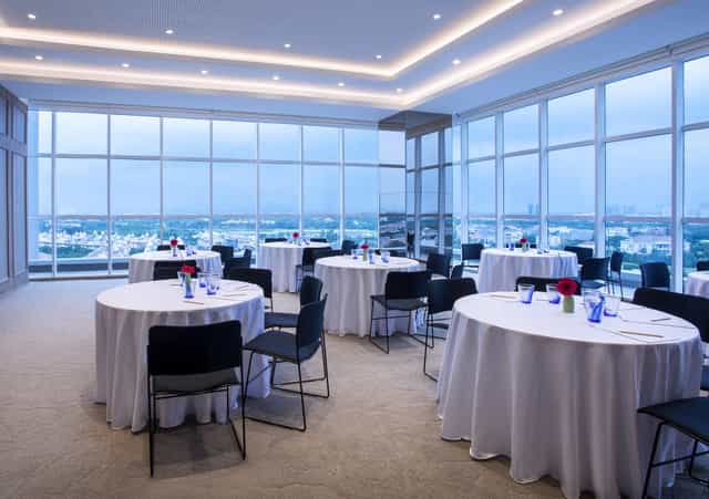 Upscale meeting room with floor-to-ceiling windows for corporate events and social luncheons.