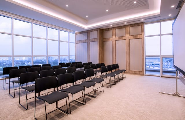 Theater-style meeting room with natural light at Mercure Jakarta PIK for corporate seminars.