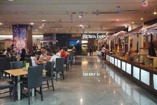 Hybrid trade expo dining area with modular vendor stalls at Jakarta International Expo.