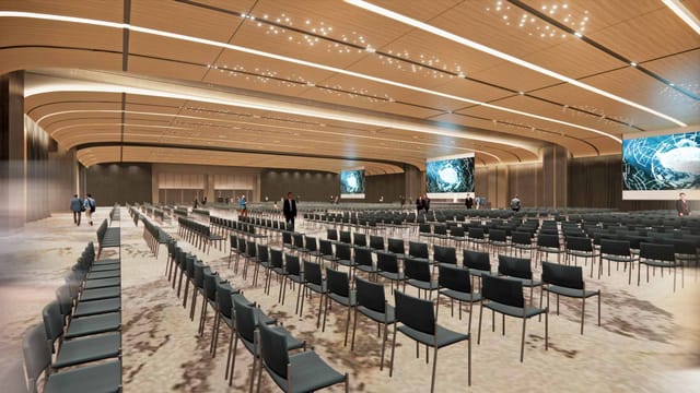 NICE semi-outdoor exhibition area with theater seating for corporate events and plenary sessions.