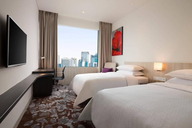 Modern twin guest room at Four Points by Sheraton Jakarta for corporate travel and conferences.
