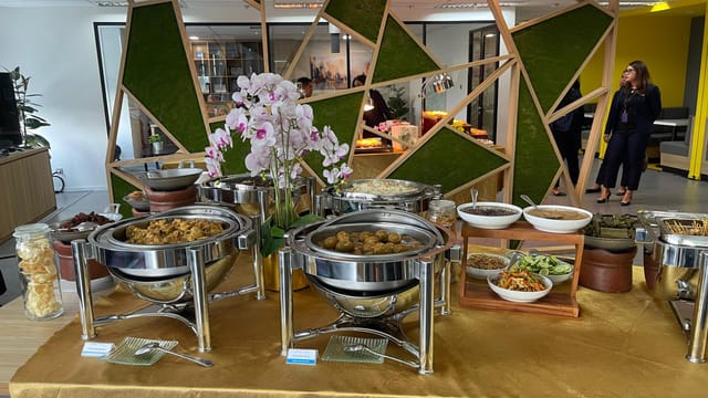 Buffet station at Aston Kemayoran City Hotel with floral centerpiece for corporate catering.