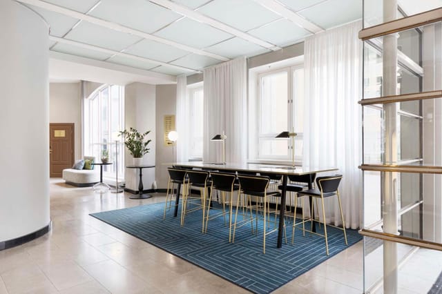 Radisson Blu Aleksanteri breakout area with high-top tables for corporate meetings and networking.