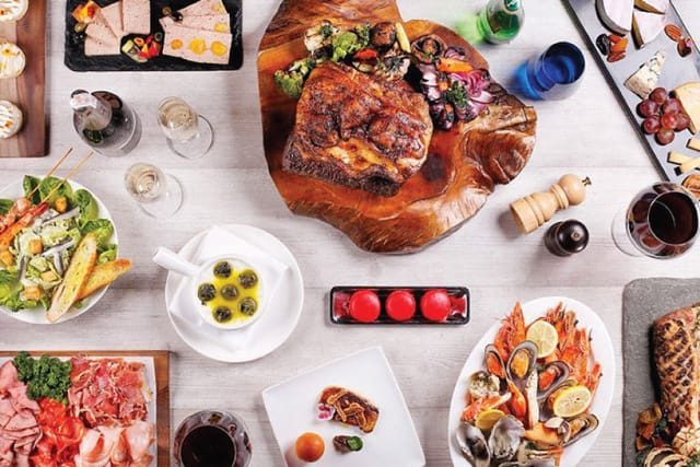 Family-style catering spread for VIP dinner or social mixer in a rustic Lyon restaurant.