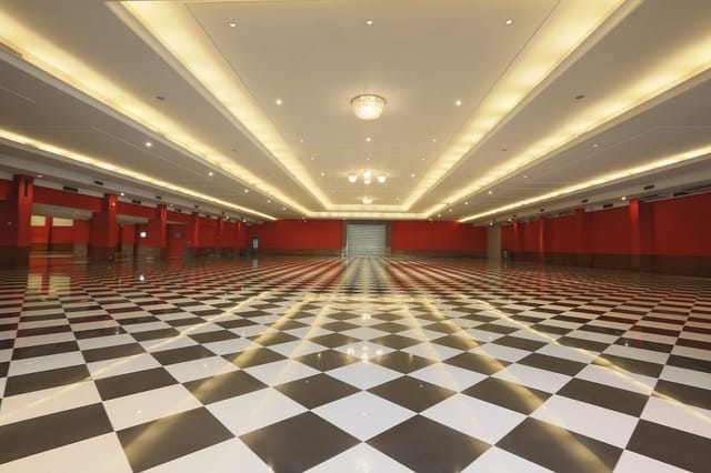 Blank-canvas convention ballroom with bold patterned floor, ideal for trade shows and conferences.