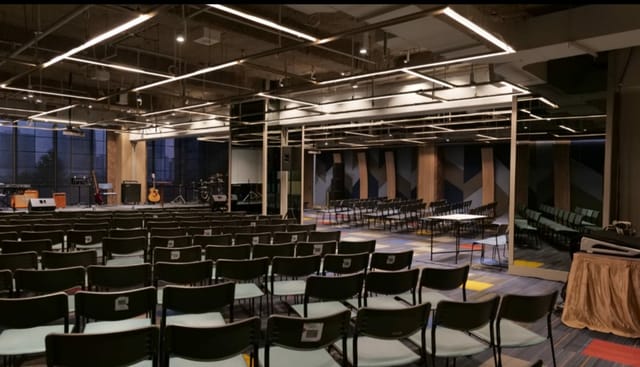 Nusantara Hall industrial venue with theater seating for corporate events and stage presentations.