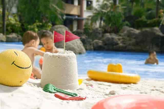 Branded poolside lounge at Grand Tropic Suites Hotel, ideal for incentive travel and family events.