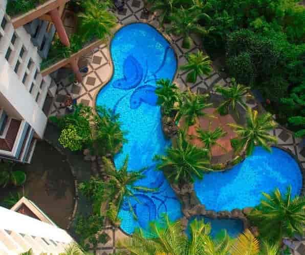 Grand Tropic Suites resort pool deck for upscale outdoor cocktail reception and networking event.