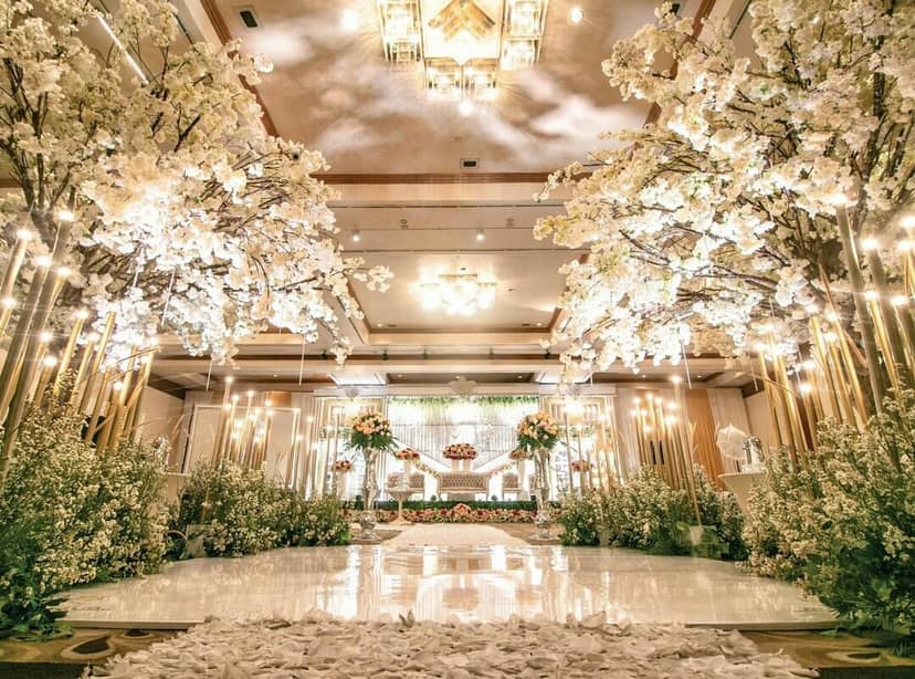 Opulent ballroom wedding setup with cherry blossoms at Millennium Hotel Sirih Jakarta.
