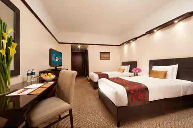 Millennium Hotel Sirih Jakarta twin room with workspace for corporate conferences and events.
