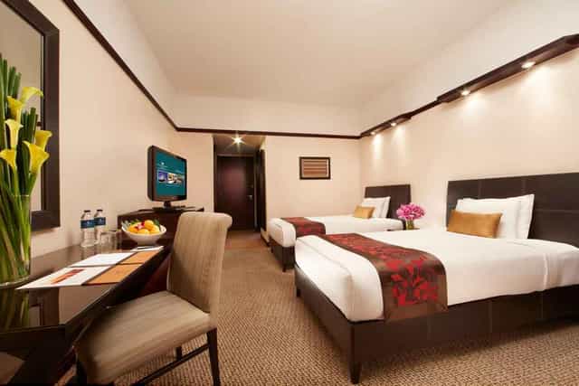 Millennium Hotel Sirih Jakarta twin room with workspace for corporate conferences and events.