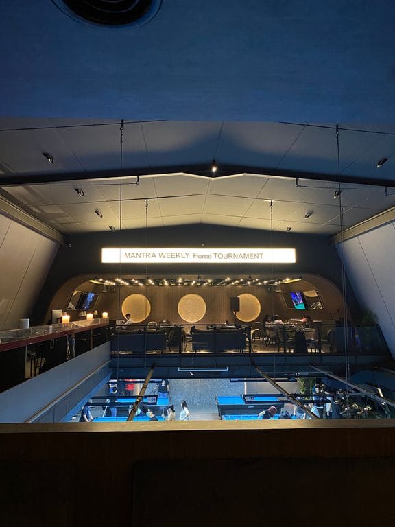 Modern Mantra Jakarta venue hosting a tournament with tiered seating and professional AV setup.