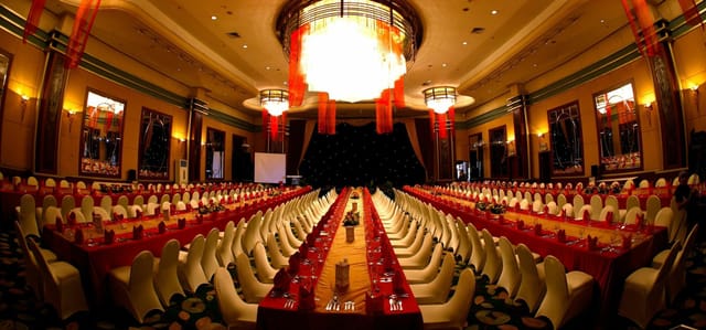 Grand Ballroom banquet setup with stage for corporate gala and convention events.