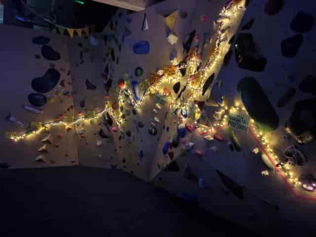 Climbing wall with colorful holds for team-building events in vibrant Rise Climbing venue.
