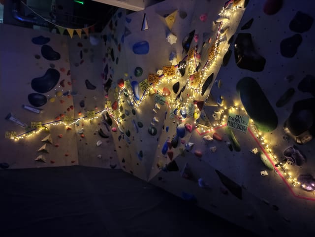 Climbing wall with colorful holds for team-building events in vibrant Rise Climbing venue.