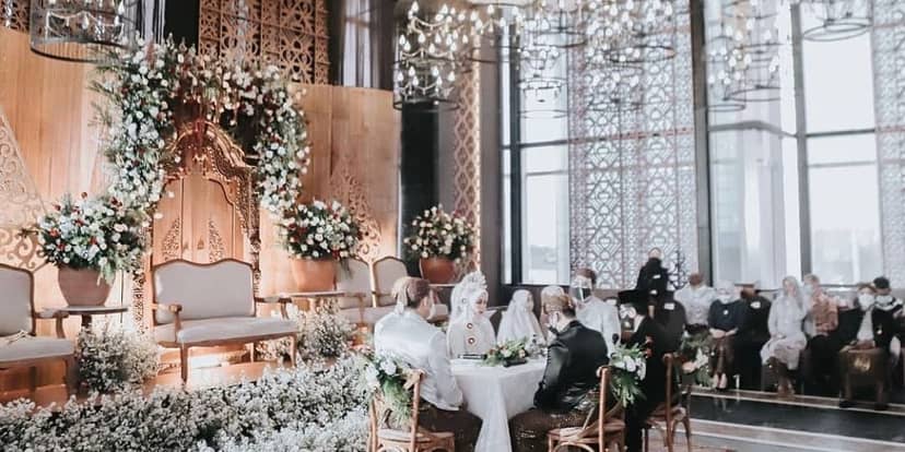 Elegant wedding stage at Grandhika Iskandarsyah with floral backdrop for luxury event decor.