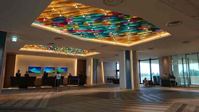 Modern Tokyo Bay hotel lobby with illuminated art for corporate event registration and conferences.