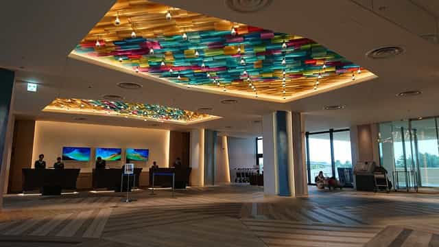 Modern Tokyo Bay hotel lobby with illuminated art for corporate event registration and conferences.