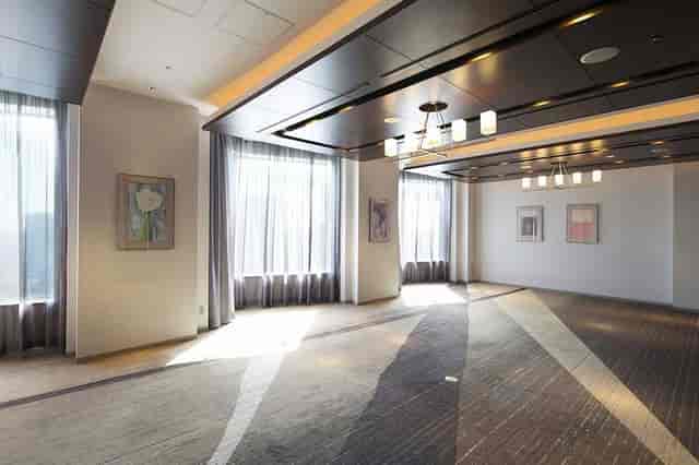 Modern event suite with natural light for upscale corporate meetings and networking receptions.