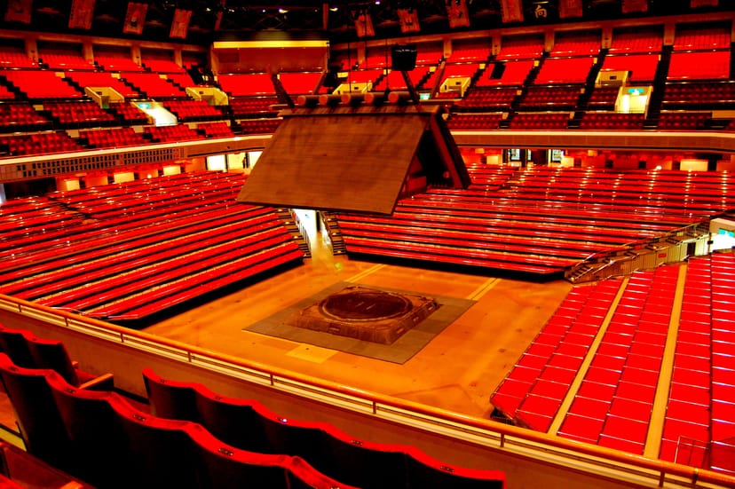 Kokugikan arena with center-stage seating for immersive event and conference venues.