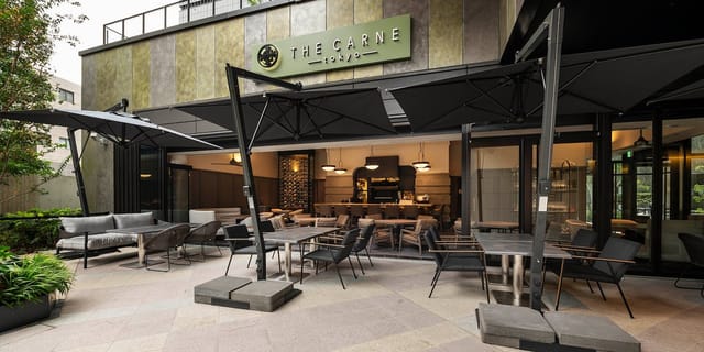 Corporate cocktail reception at THE CARNE TOKYO featuring flexible indoor-outdoor lounge seating.