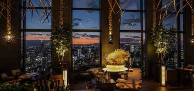 Hokushin VIP event venue at Shinagawa Prince Hotel with dramatic sunset backdrop.