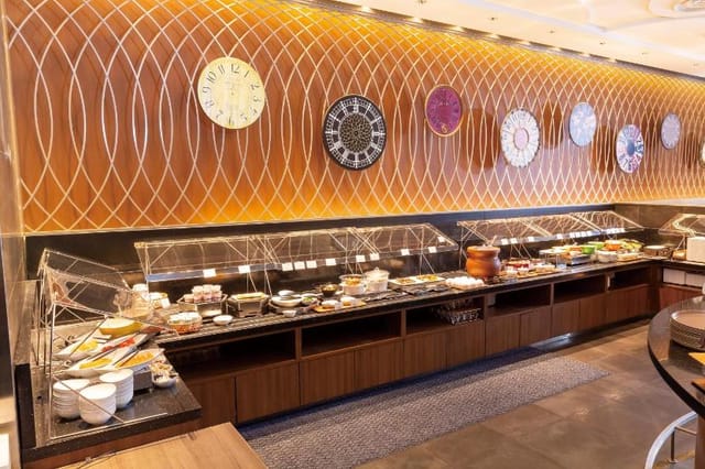 Modern hotel breakfast buffet with sneeze guards for conference catering.