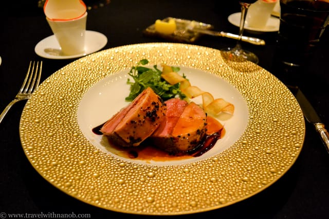 Gala dinner at Chateau Restaurant Joel Robuchon with gold-rimmed plates for luxury event catering.