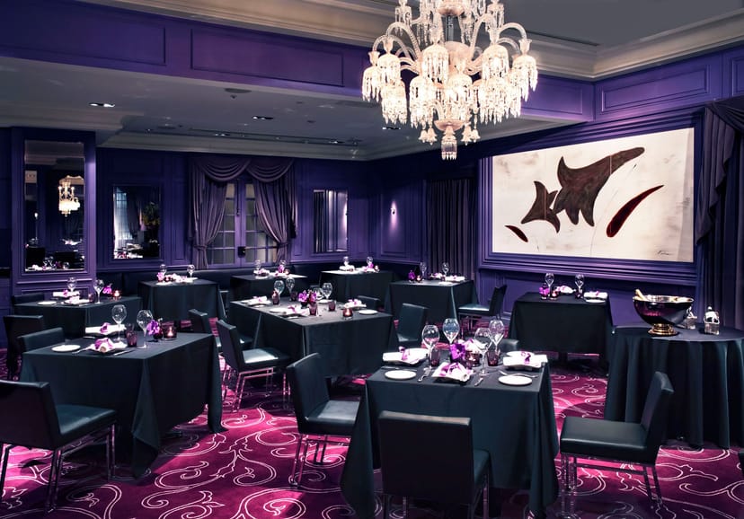 Private dining room at Chateau Joel Robuchon with purple decor for executive dinner or networking.