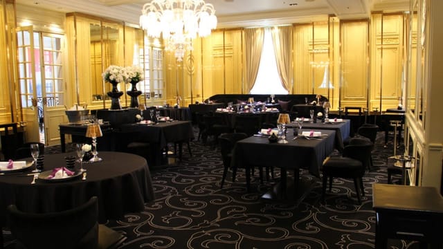 Private dining room at Chateau Joel Robuchon with gold walls, perfect for gala dinner or reception.