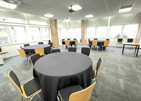 Cabaret-style workshop space at Edmund House featuring breakout rounds for corporate events.