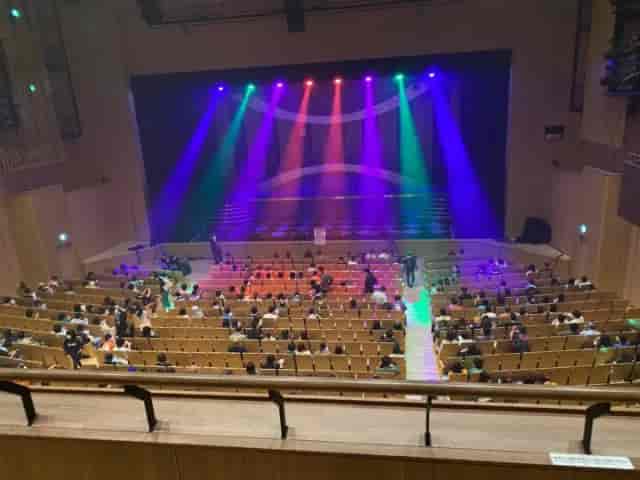 VIP seating at LINE CUBE SHIBUYA with colorful stage lighting for corporate event or conference.